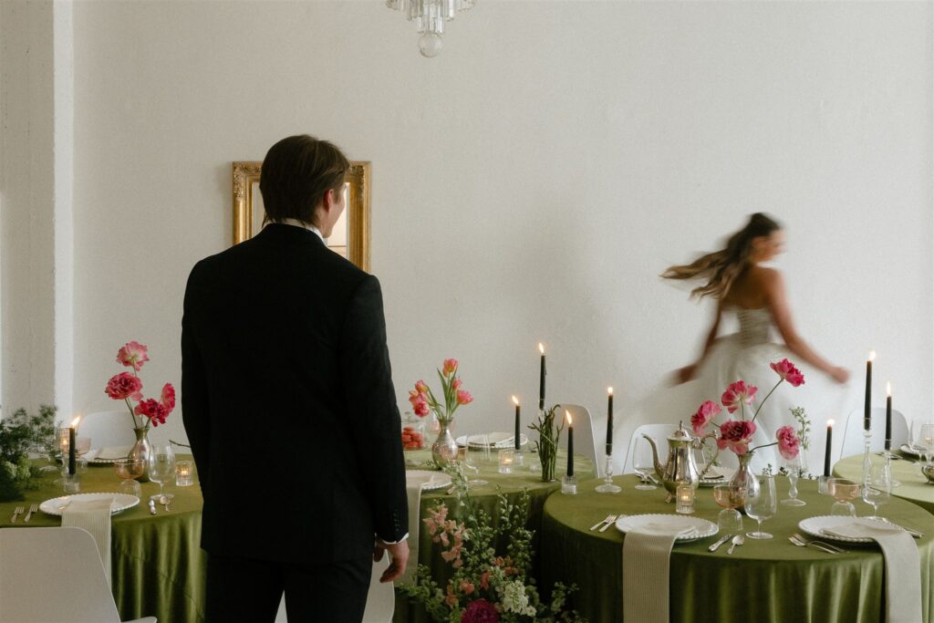 Groom admires bride as she twirls around their microwedding space