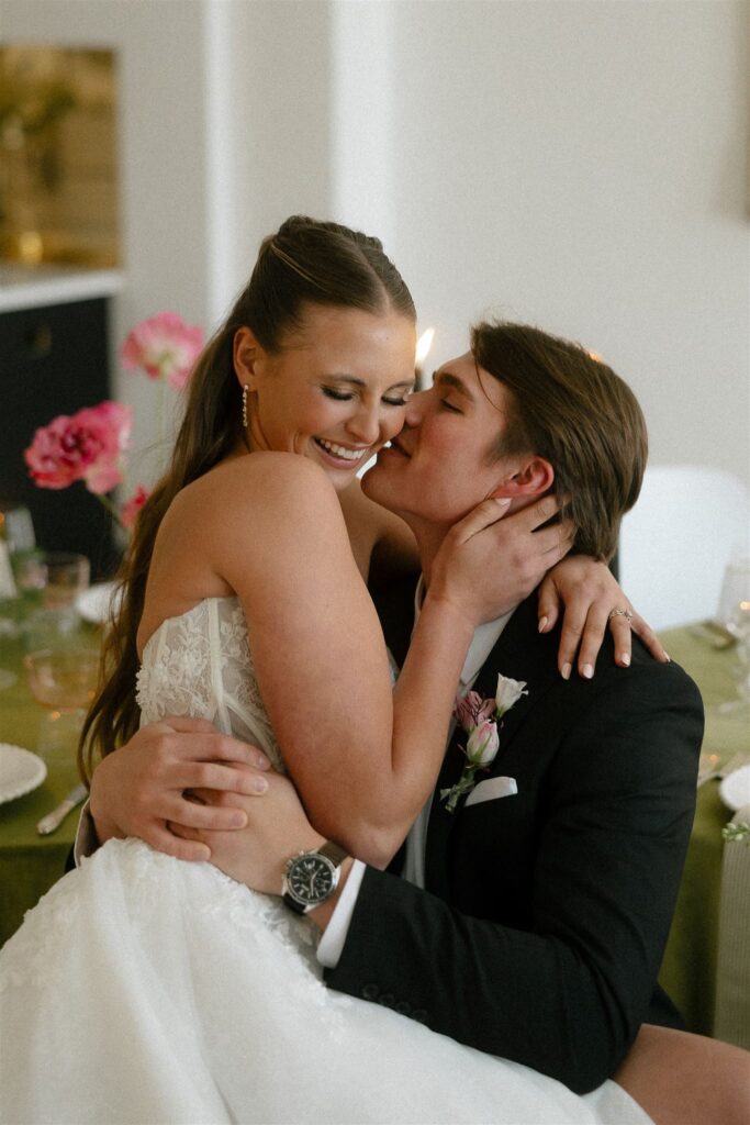 Groom whispers into bride's ear