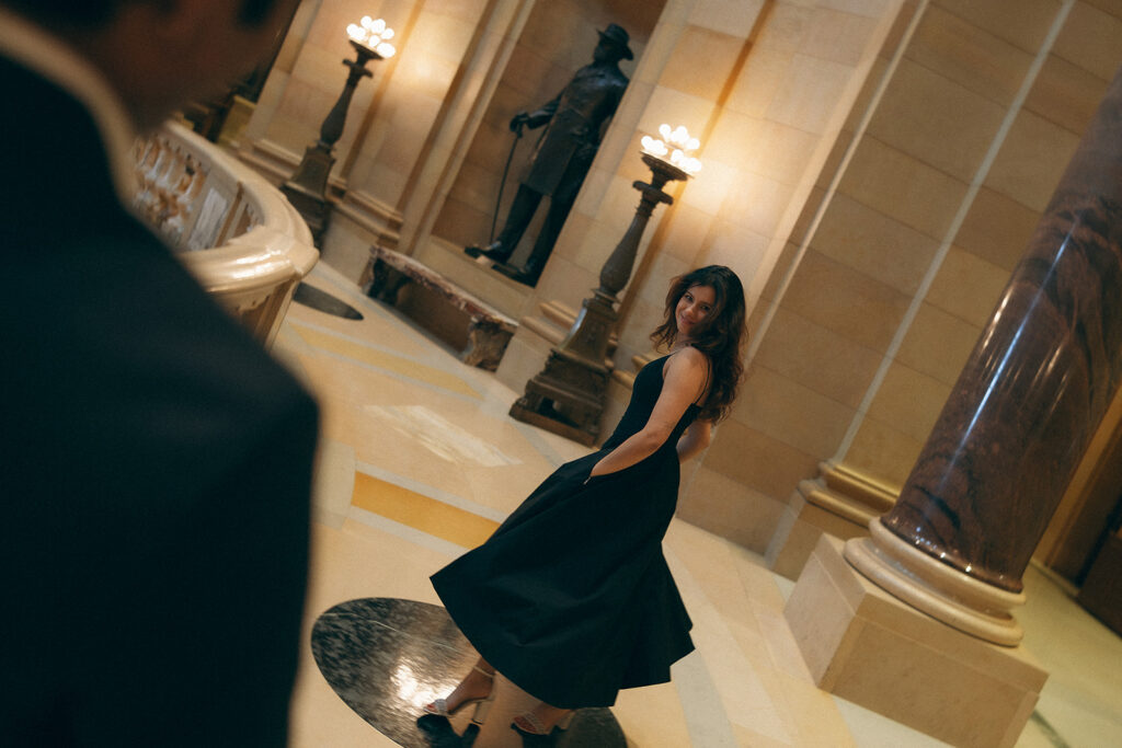 Shubhi twirls with arms wide, skirt fanned out, while Abhi watches with a grin—pure cinematic engagement photo energy.