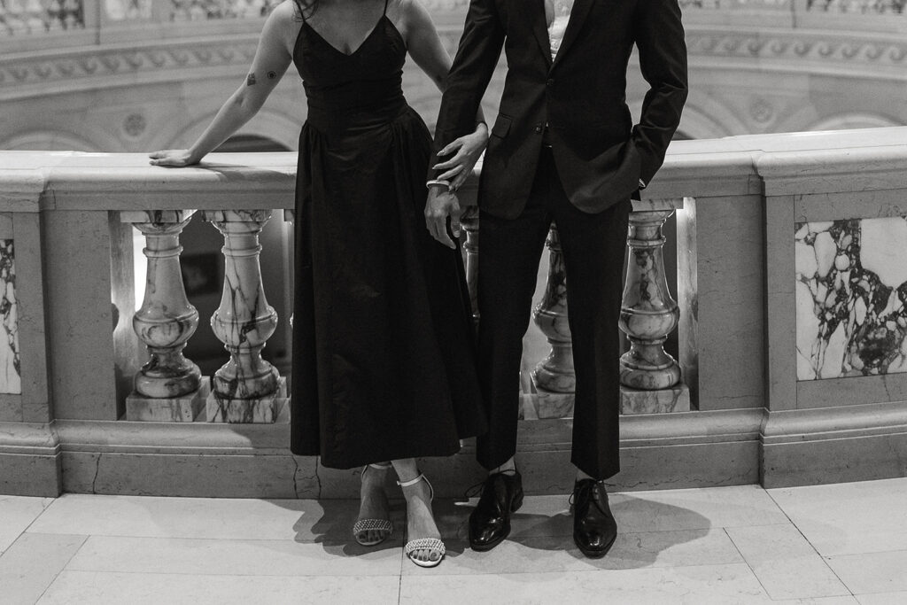 Well-dressed couple intertwines hands