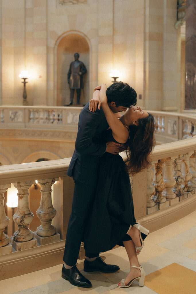 Couple laughing mid-spin on Capitol steps, capturing cinematic engagement photo magic