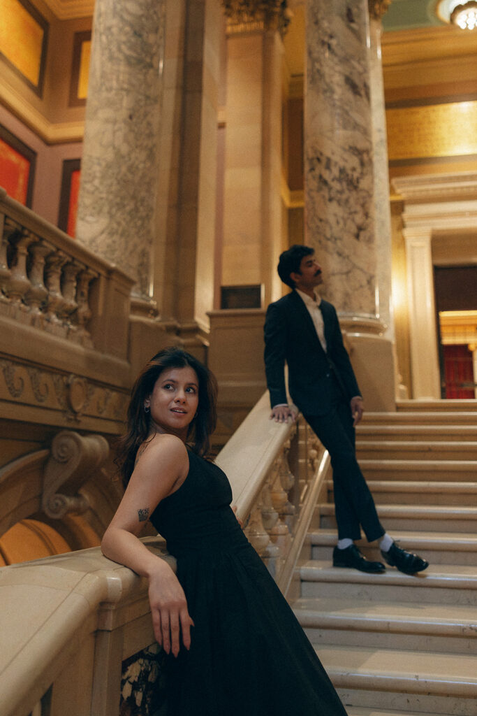 Couple leans against marble railway at Minnesota Capitol in Saint Paul