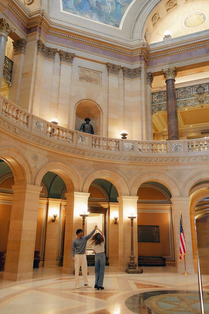 Low-angle couple shot with Capitol columns towering above