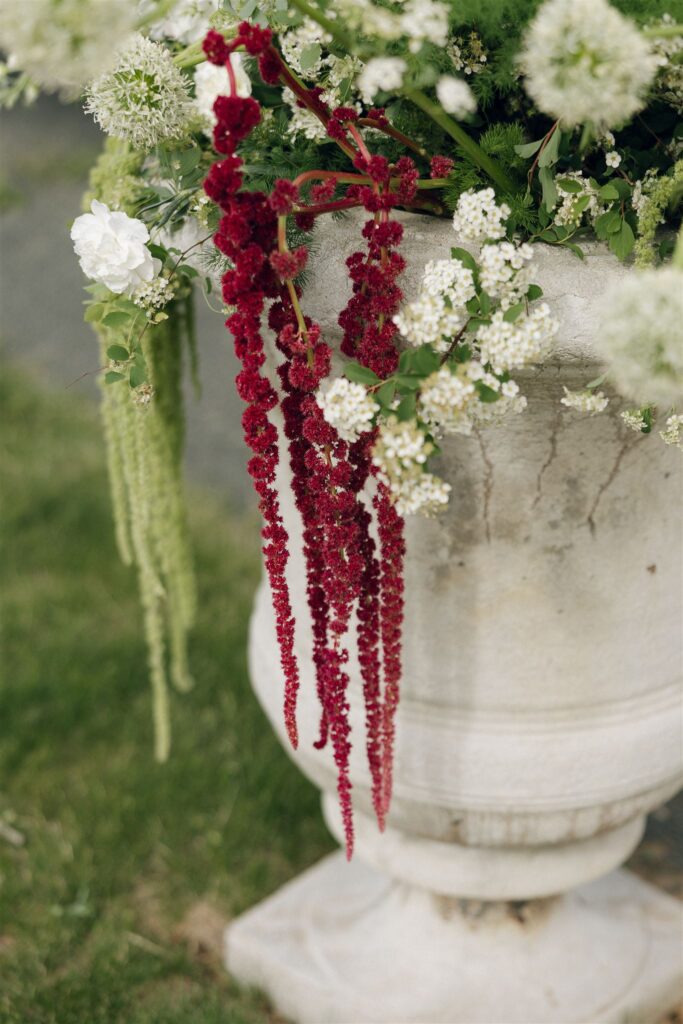 Statement floral urn with cascading amaranthus at the Edward Anne Estate ceremony site.