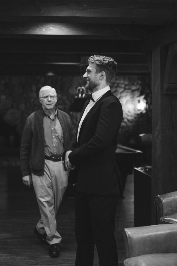 Groom sharing a quiet pre-ceremony moment with his dad in the lounge