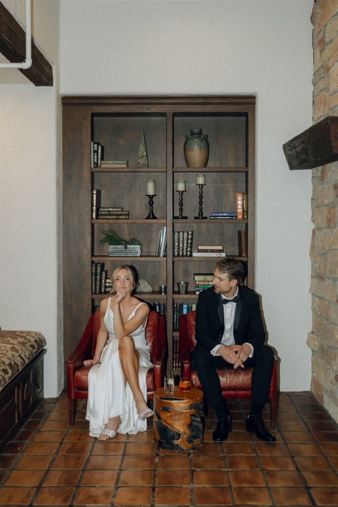 Bride and groom sharing a private moment in the Edward Anne Estate library, surrounded by vintage decor