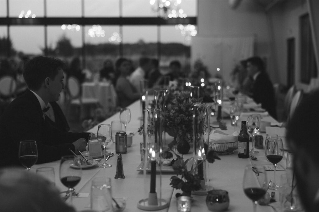 Reception dinner table glowing with candlelight