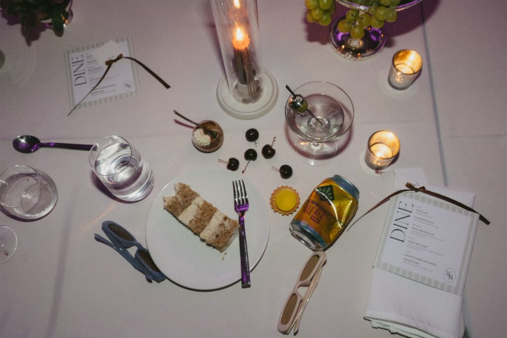 Tabletop close-up of espresso martinis, cherries, and cake remnants after the party.
