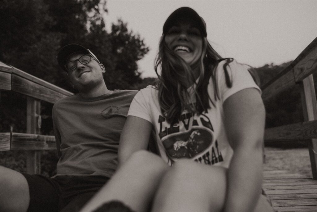 Couple sitting together on a hammock, smiling and relaxed.