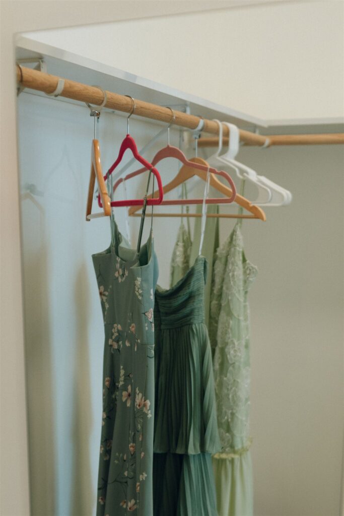 Bridesmaids’ dresses hanging in the prep suite.