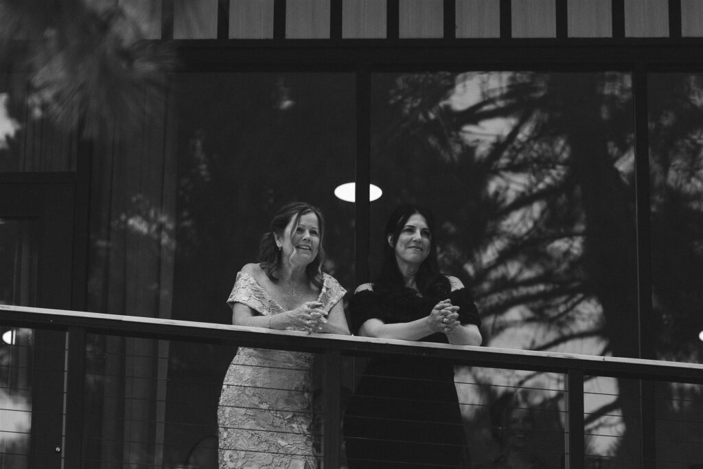 Mothers watching the couple’s first look from the balcony.