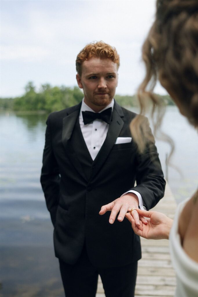 Groom showing his wedding ring during portraits.