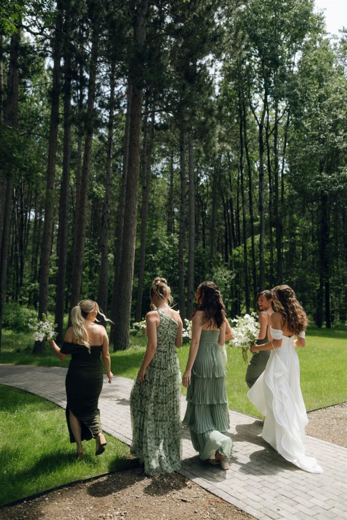 Bride laughing with bridesmaids during portraits.