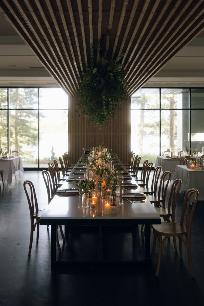 Candlelit reception tables with greenery in documentary style wedding photos.