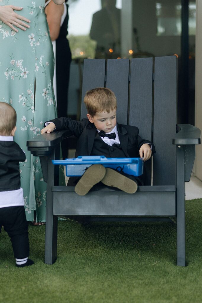 Young boy sitting in a chair with Hot Wheels cars.