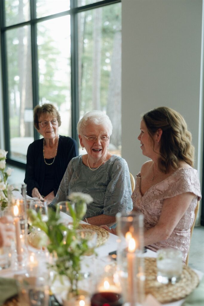 Older guests socializing and laughing during toasts.