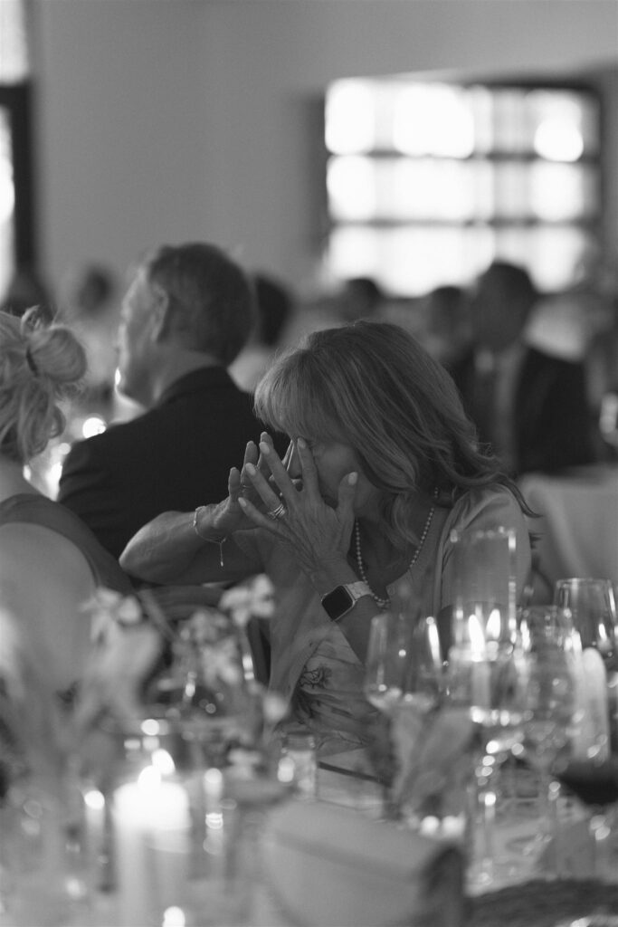 Wedding guest wiping away tears.