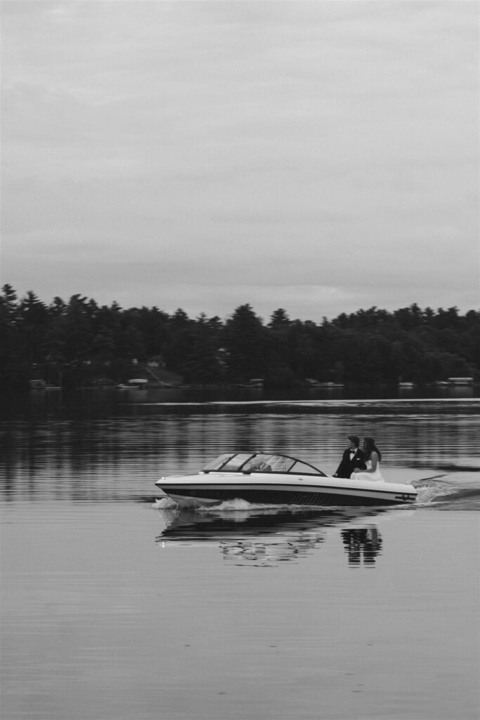 Speedboat pulling away from the dock at Catalyst at Nature Link, wide lake view.