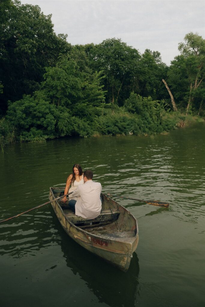 Sophie laughs as Jake attempts to corral the rowboat in storytelling engagement photos.
