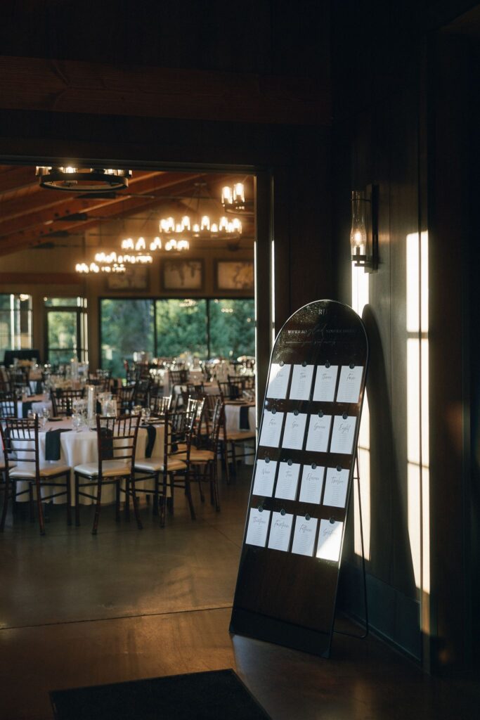 Modern seating chart displayed inside 7 Vines Vineyard and Winery, positioned near the reception space at a contemporary Minnesota wedding venue.