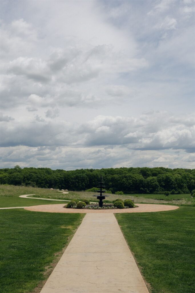 Wide view of Edward Anne Estate at Bavaria Downs featuring the fountain courtyard and surrounding gardens, highlighting the scale of this Minnesota wedding venue.
