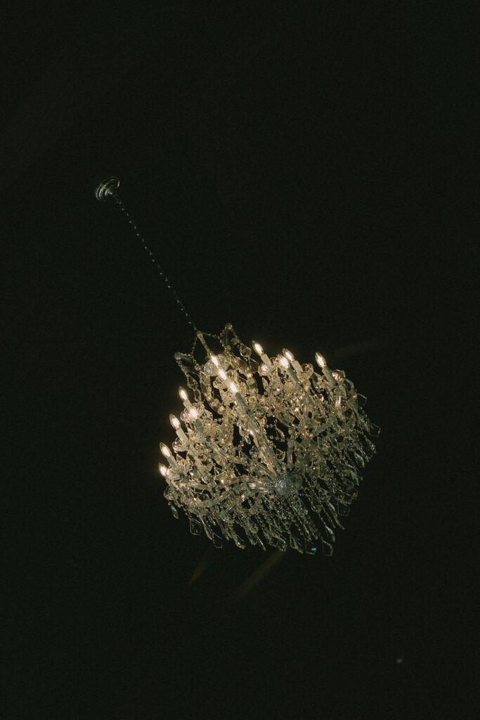 Crystal chandelier hanging inside Woods and Co Weddings and Events, highlighting refined interior details found at top Minnesota wedding venues.