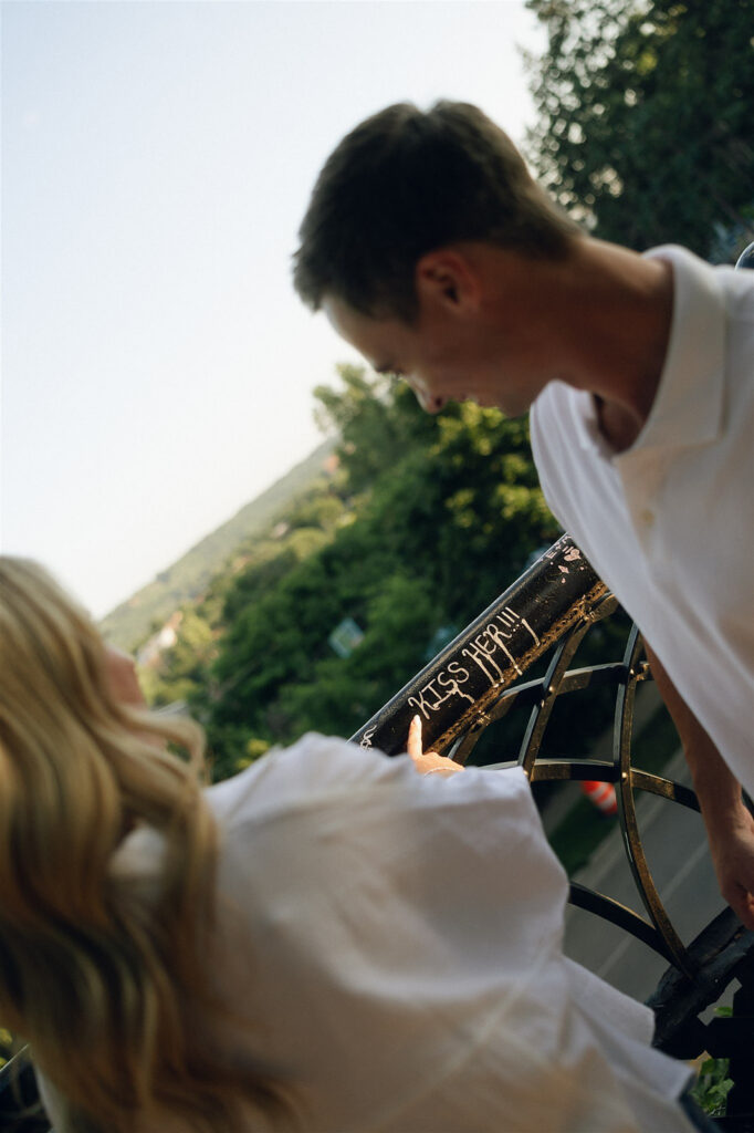 Golden hour close-up of an engaged couple touching foreheads, her engagement ring visible against his shoulder during their intimate St. Paul engagement session.